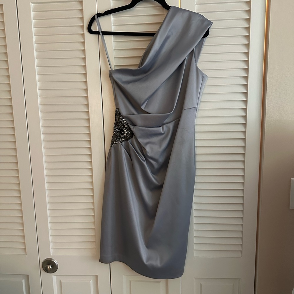 Fun and flirty gray one shoulder cocktail dress with waist embellishment